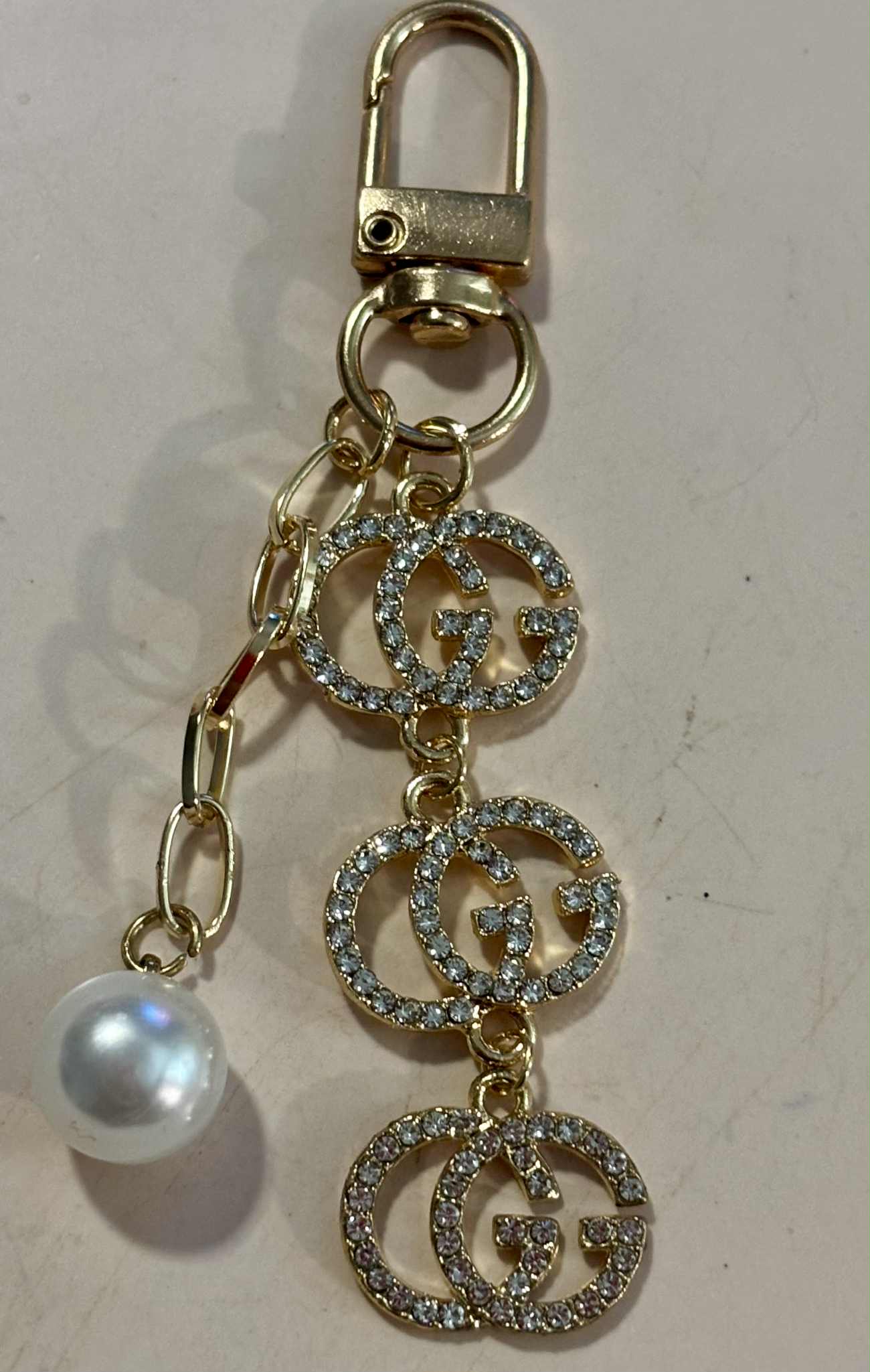 Bag charm G pearl gold 3"